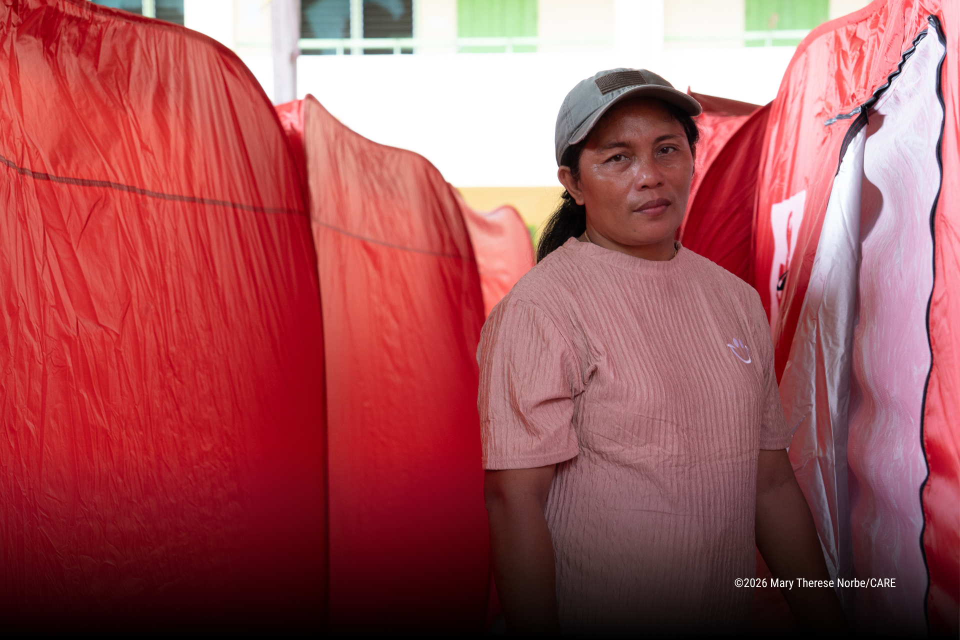 Melanie Sangalan standing at the evacuation center in Malapatan, Sarangani, where she and other families are temporarily staying.